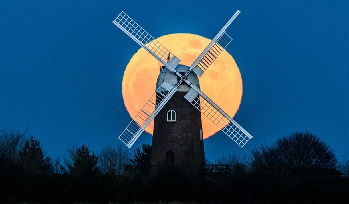 windmill reference, dark sky, moon behind windmill